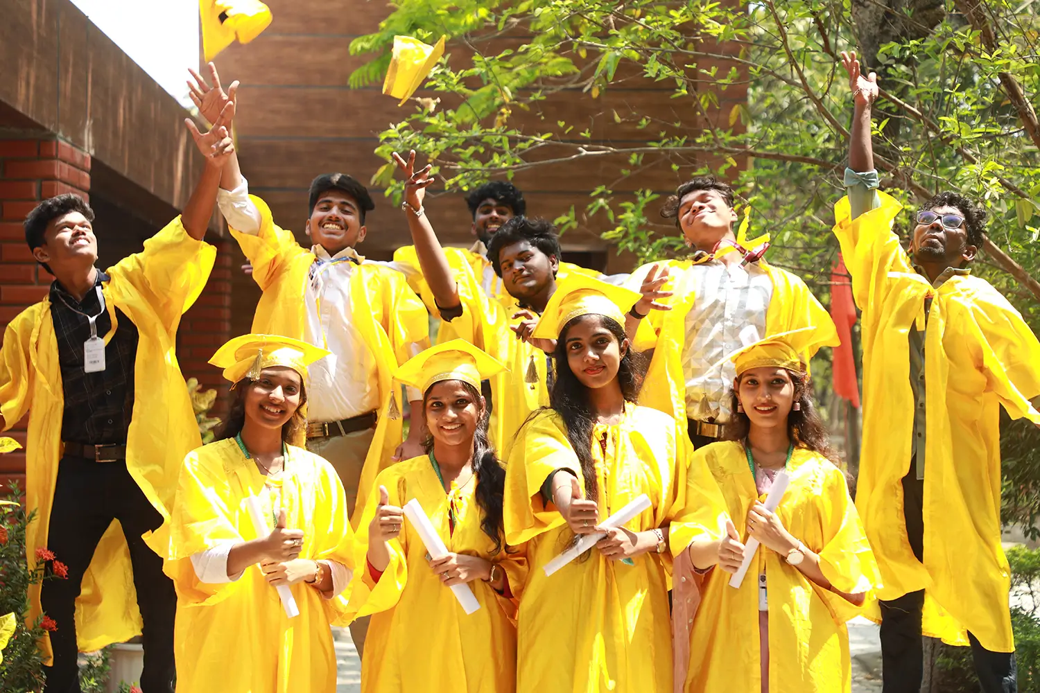 students celebrating in graduation attire